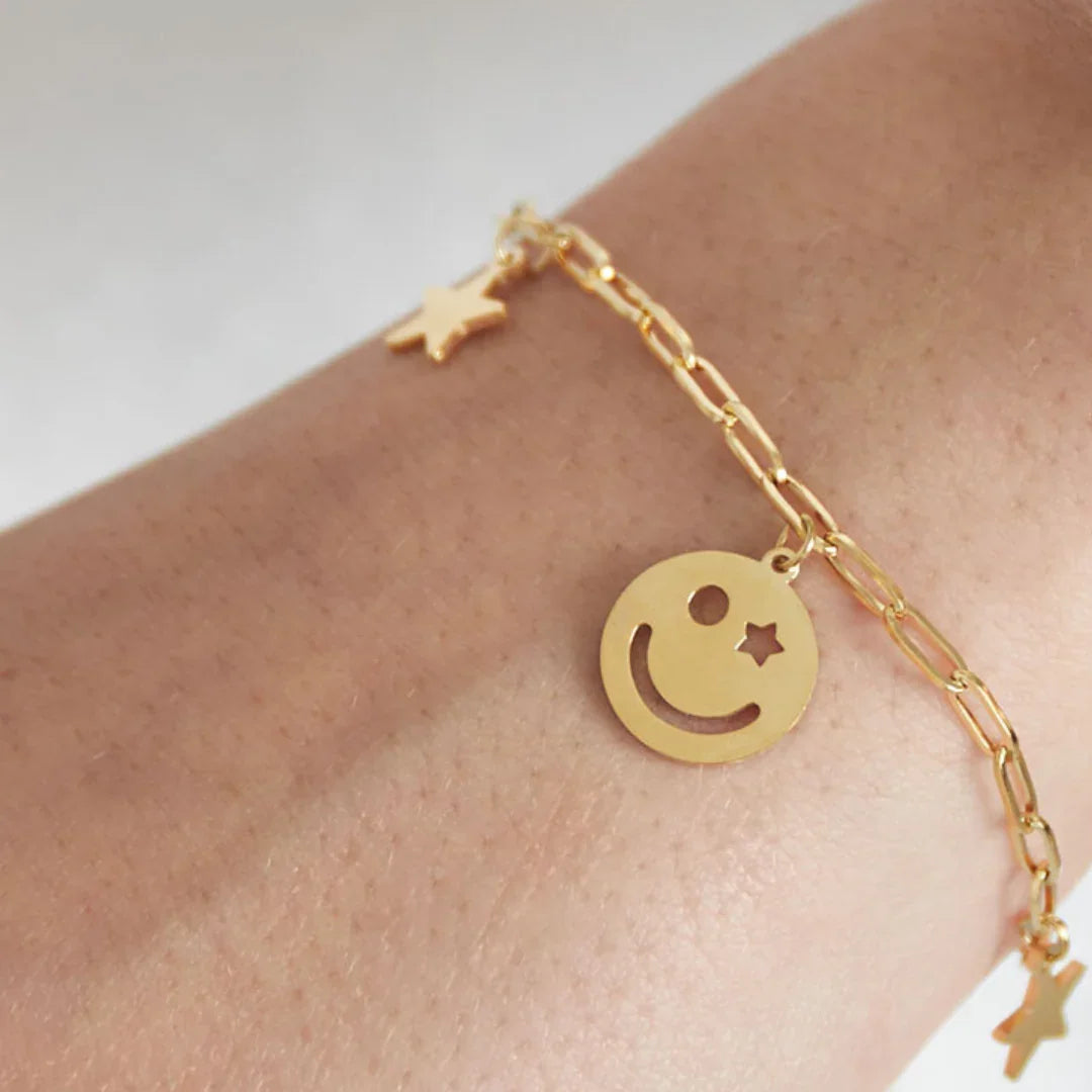 Gouden armband met sterretjes en smileys bedels - Casa Jadel
