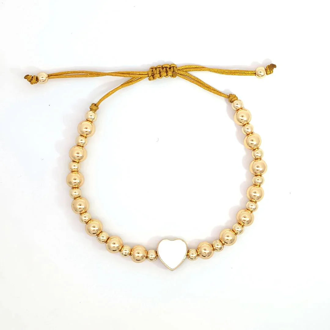 Verstelbare gouden armband met 2 maten kraaltjes en een wit hartje - Casa Jadel