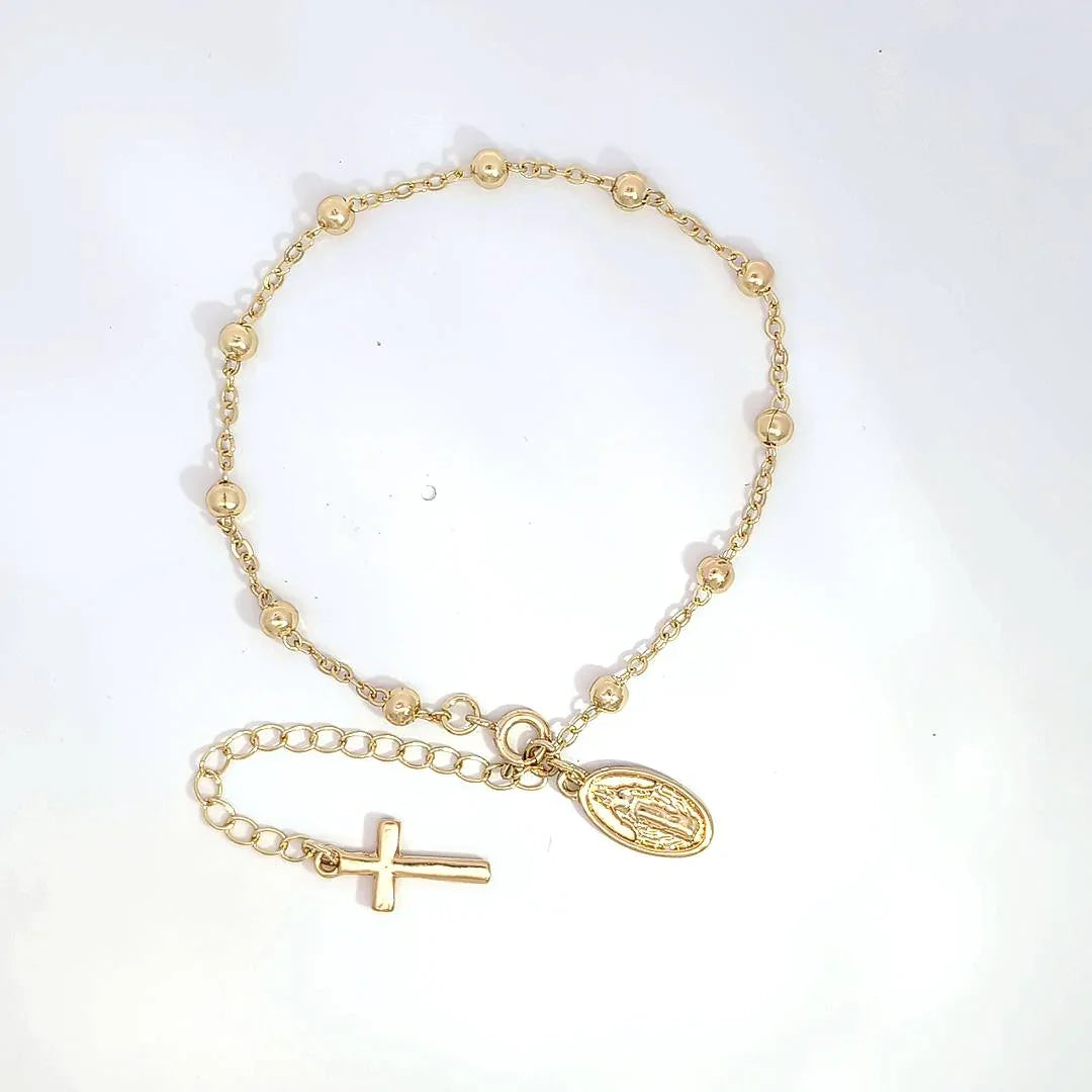 Schakelarmband met bolletjes een bedeltje met heilige en aan het verlengstukje een kruis - Casa Jadel