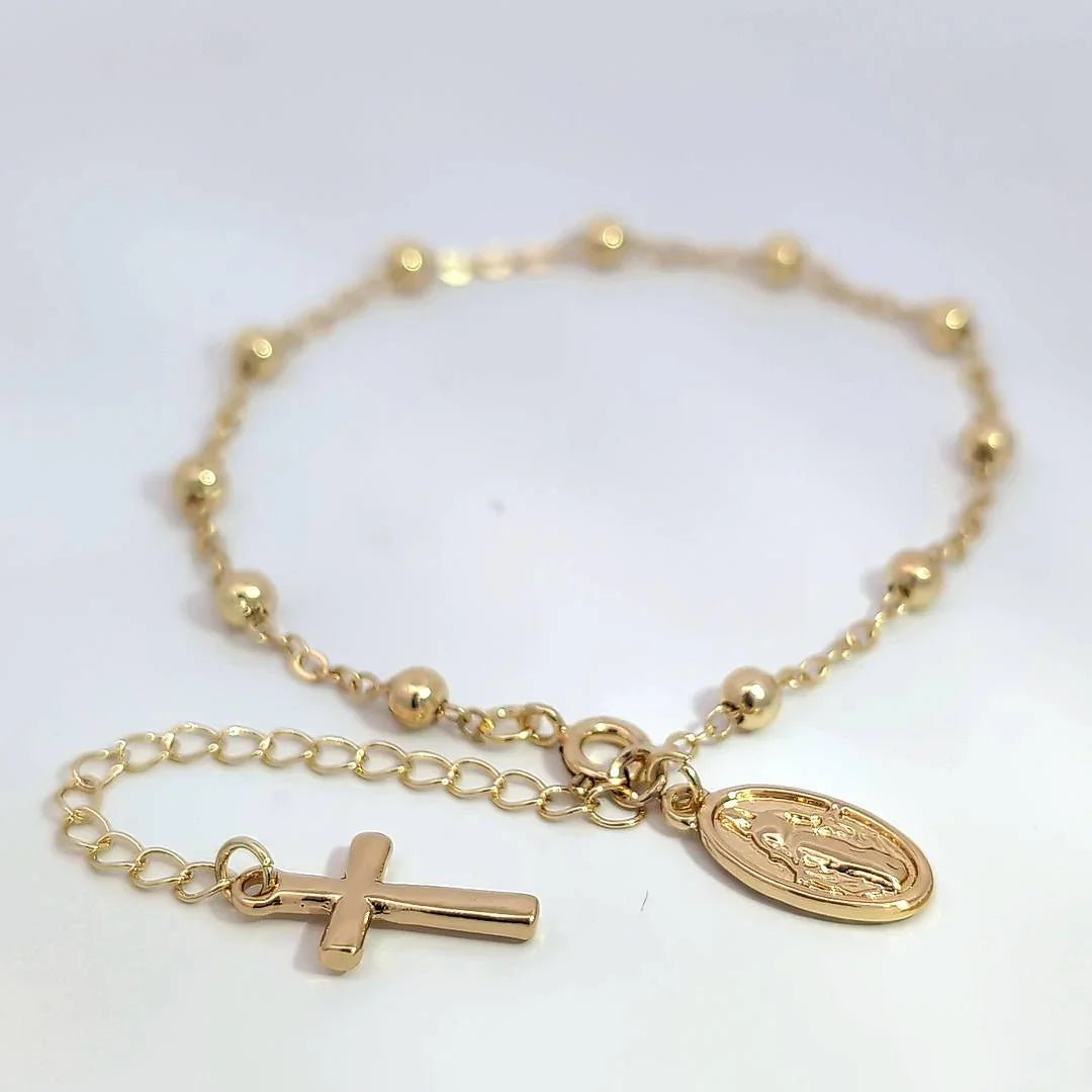 Schakelarmband met bolletjes een bedeltje met heilige en aan het verlengstukje een kruis - Casa Jadel