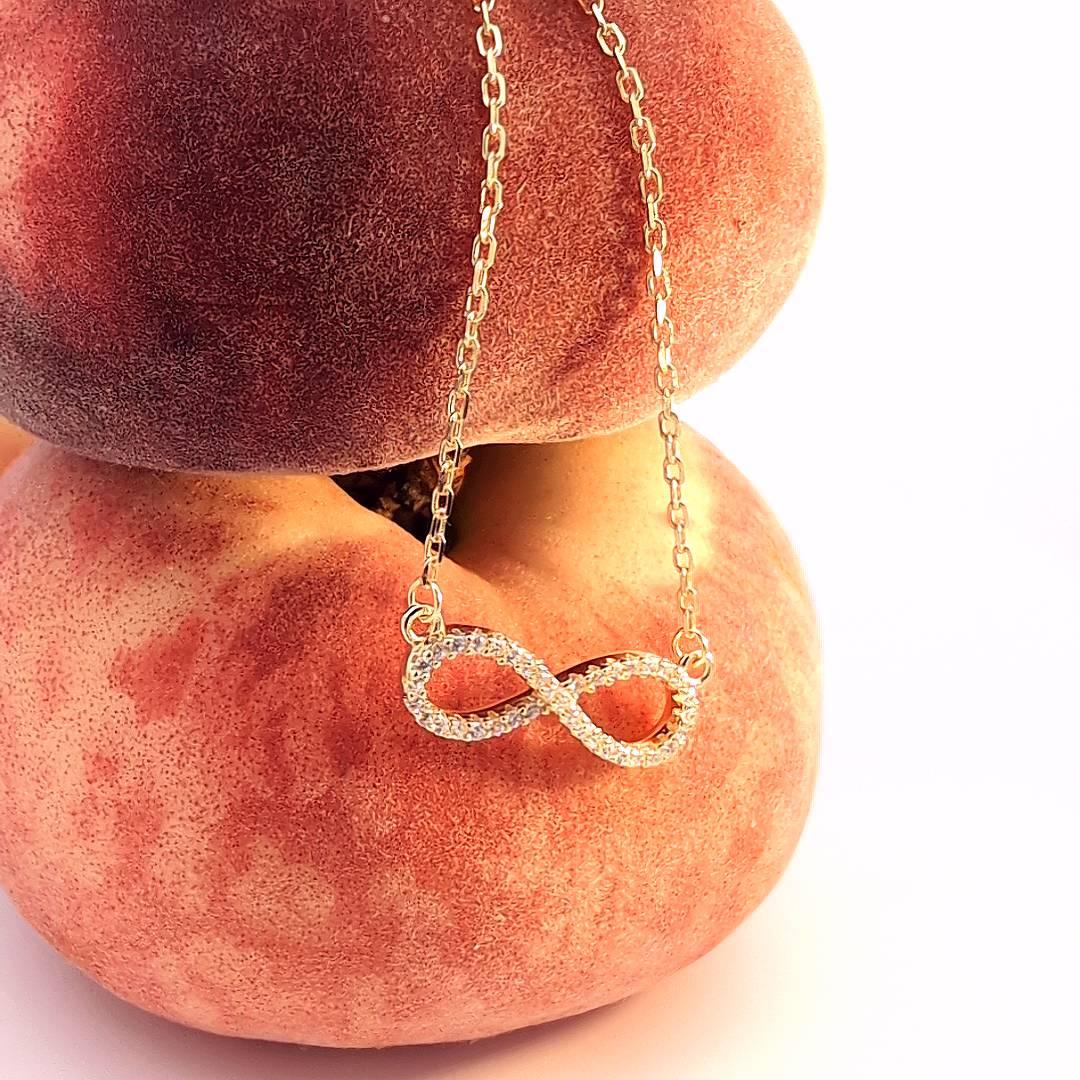 Ketting goudkleurig oneindig hanger afgezet met strass - Casa Jadel