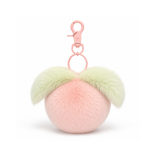 Perzikkleurige fruit pompon tashanger met hartje in perzik, groen en goudkleurig voor aan een tas