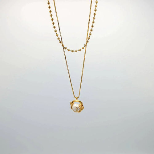 Lange dubbele ketting goud met hanger en parel