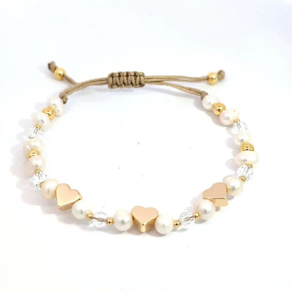 Verstelbare armband met gouden hartjes kraaltjes en pareltjes - Casa Jadel