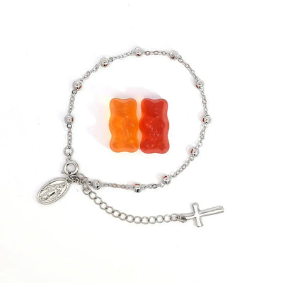 Schakelarmband zilver met bolletjes een bedeltje met heilige en aan het verlengstukje een kruis