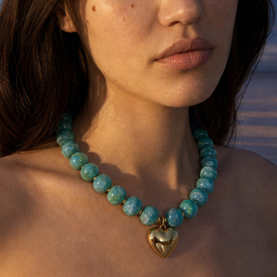Turquoise ovale marble kralenketting Tes met gouden hart