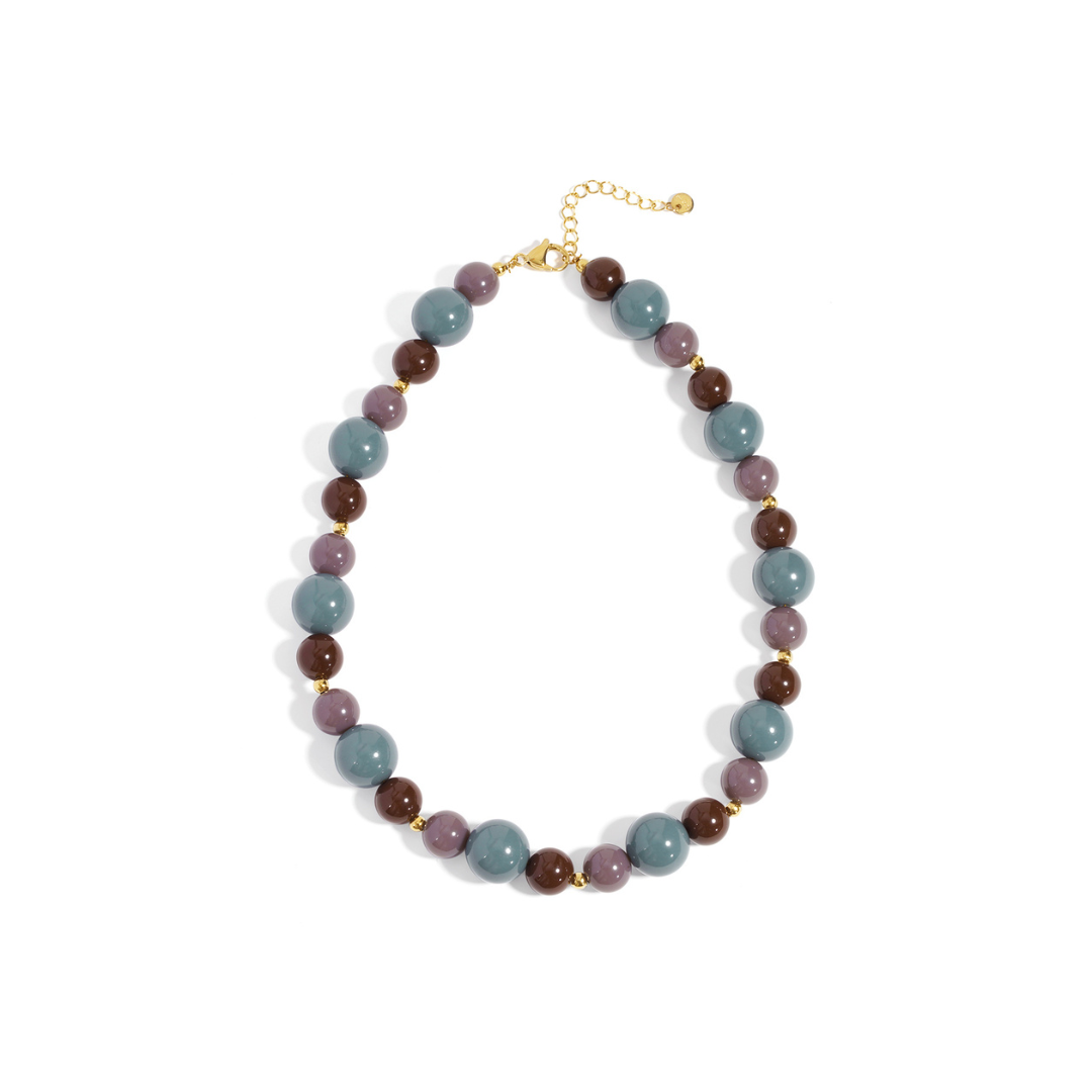 Kralenketting in blauw, paars en bruin met glanzende beads en goudkleurige verstelbare sluiting.