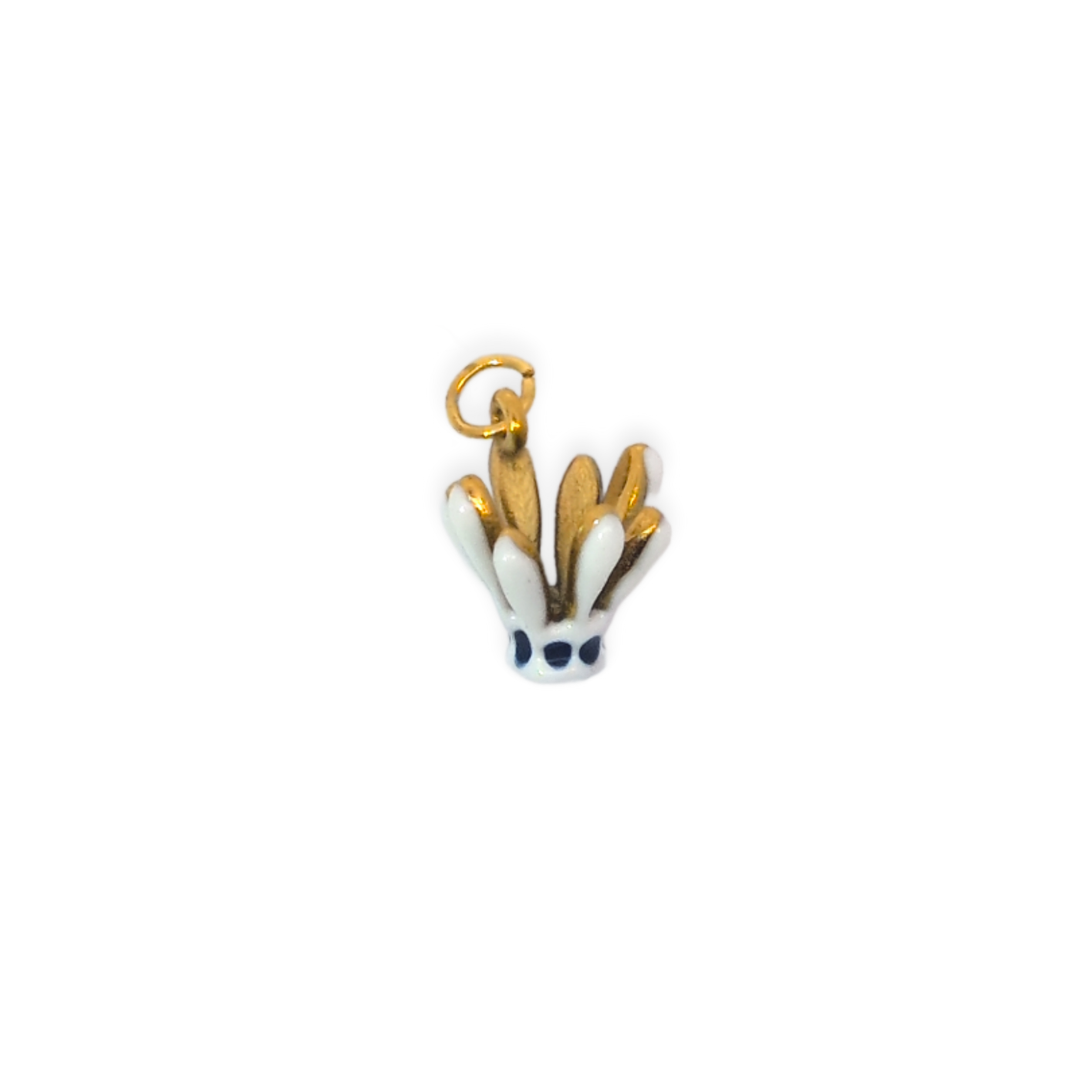 Witte badminton shuttle bedel met gouden details en donkerblauwe accenten