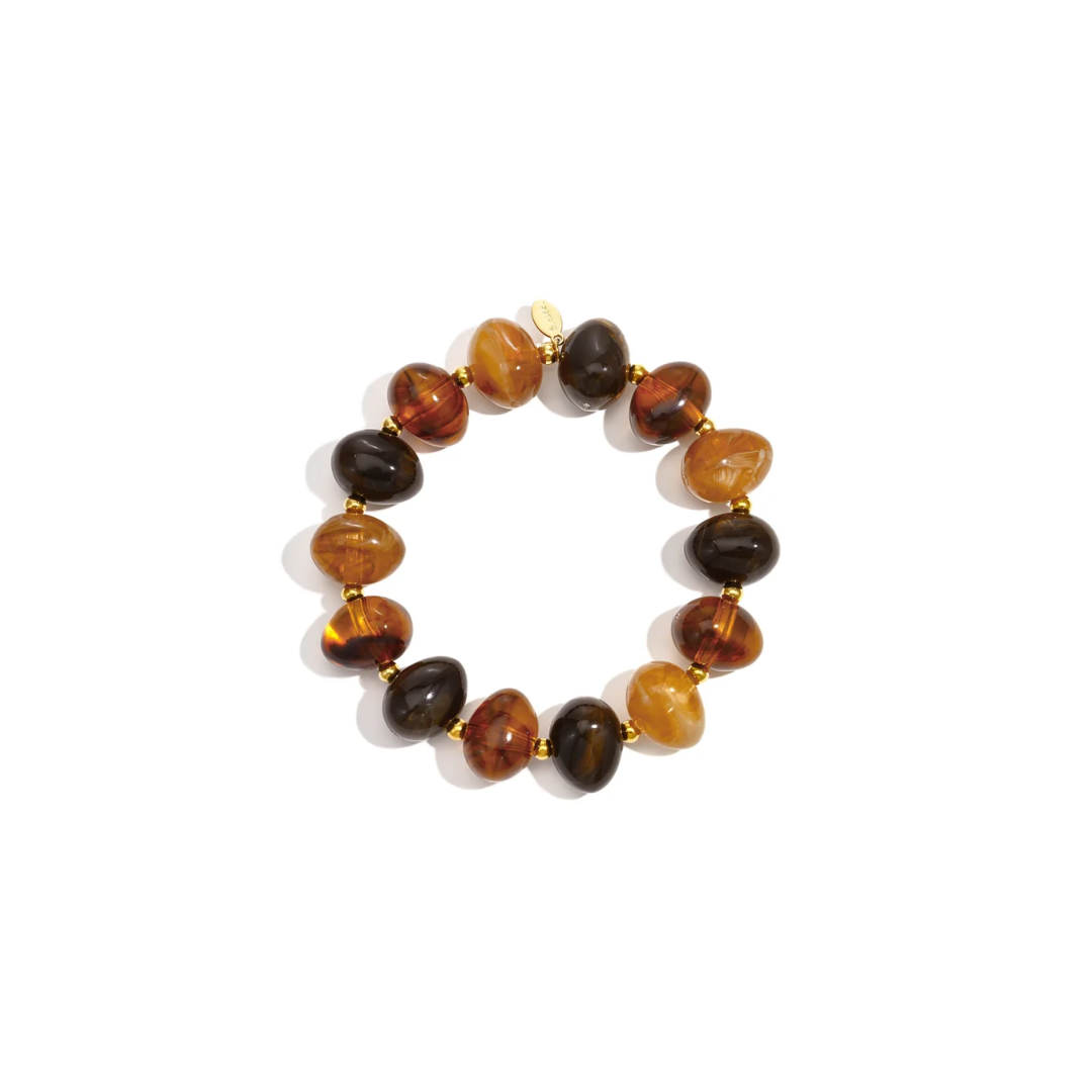 Amber bruine chunky kralenarmband met grote transparante en gemarmerde kralen in cognac en chocoladebruin met gouden tussenkralen