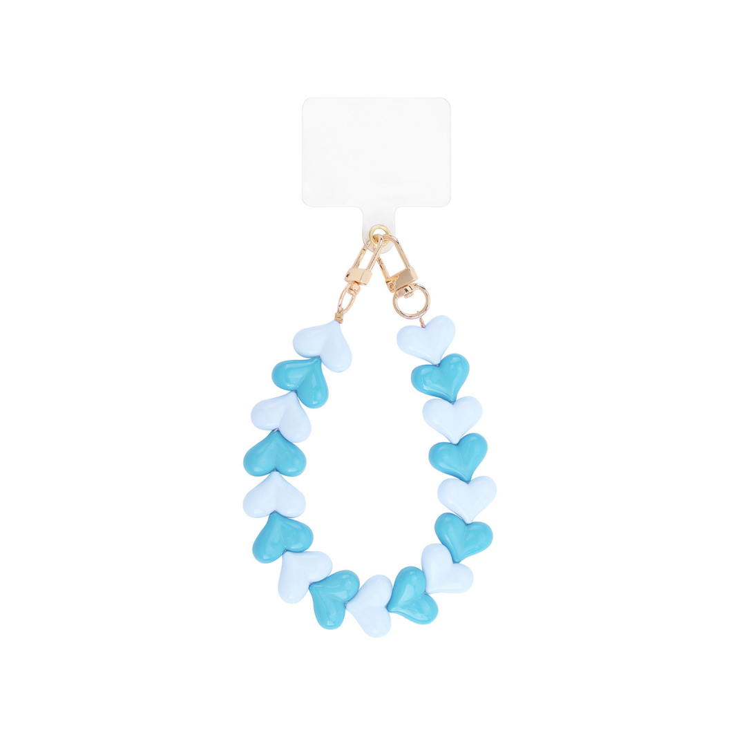 Combineer dit blauwe hartjes telefoonkoord met wit, denim of beige voor een frisse look. Ook prachtig bij zandtinten of als koel contrast bij warme kleuren. Match met goudkleurige sieraden of een blauwe kralenketting voor een mooie samenhang.