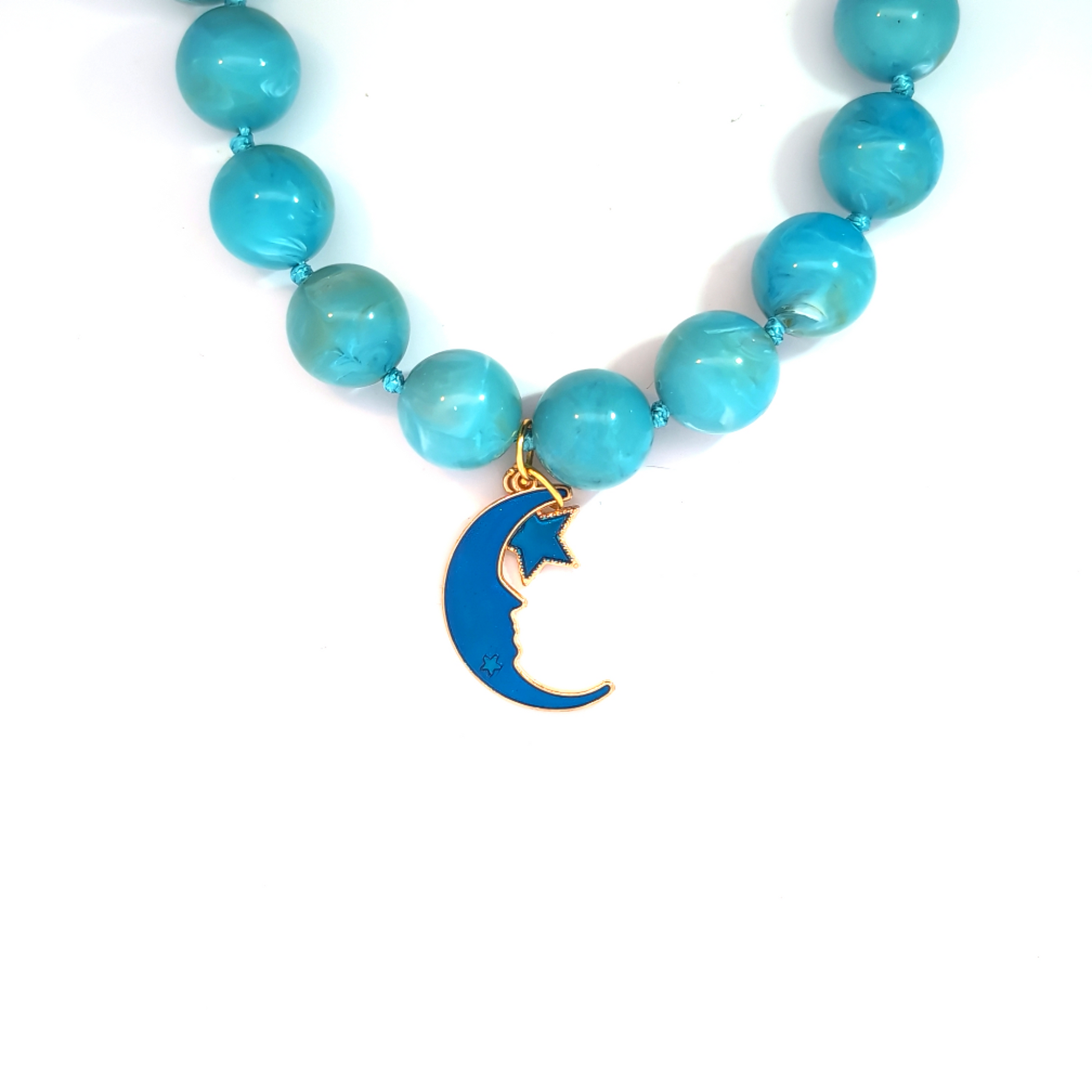 Blauwe maan en ster bedels gedragen aan blauwe kralenketting, Jadel style
