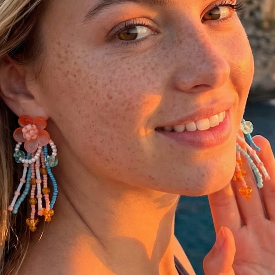 Model draagt bloem oorbellen met kraaltjes Ibiza Style.