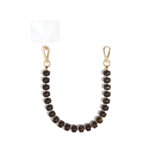 Bruin chunky kralen telefoonkoord Faye met glanzende chocoladebruine marble kralen, goudkleurige tussenkraaltjes, twee karabijnsluitingen en transparant bevestigingsplaatje.