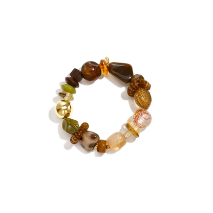 Bruin en groene chunky kralenarmband met verschillende statement kralen en gouden detail