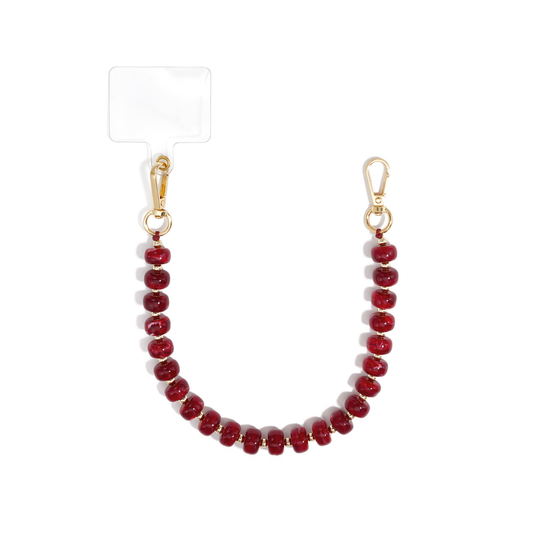 Burgundy chunky kralen telefoonkoord Faye met glanzende dieprode kralen, goudkleurige tussenkraaltjes en twee gouden karabijnsluitingen