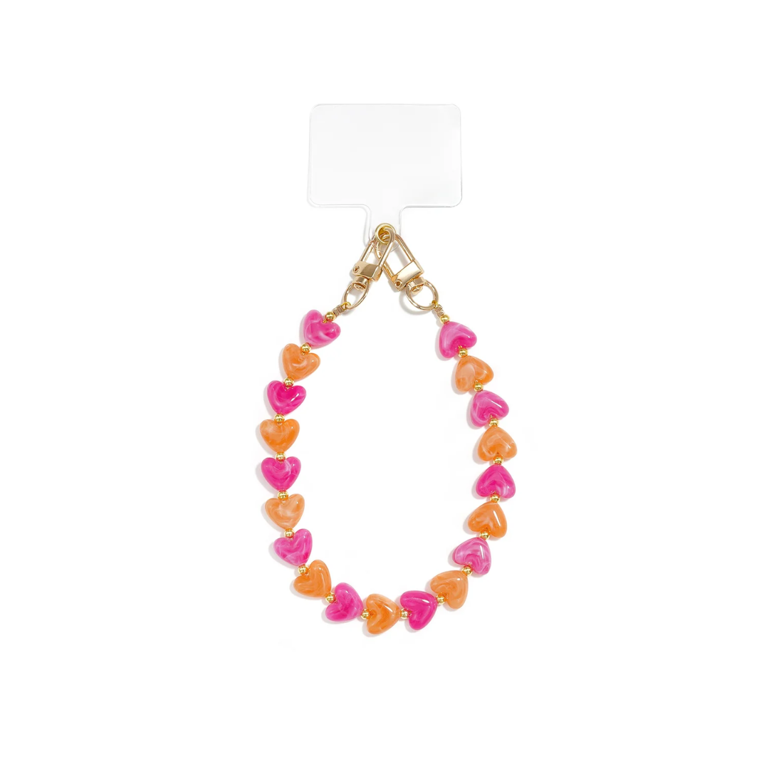 Fuchsia-oranje marble hartjes telefoonkoord met fuchsia en oranje hartjes en goudkleurige details van Casa Jadel.