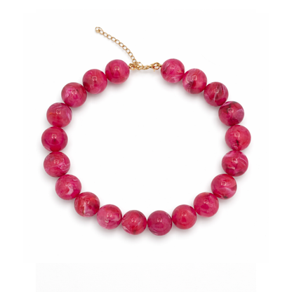 Fuchsia roze grote kralenketting met marble effect en goudkleurige sluiting.