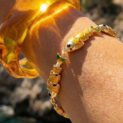 Gouden visjes armband met groene accenten