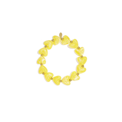 Gele hartjes kralenarmband met goudkleurige details in Ibiza style