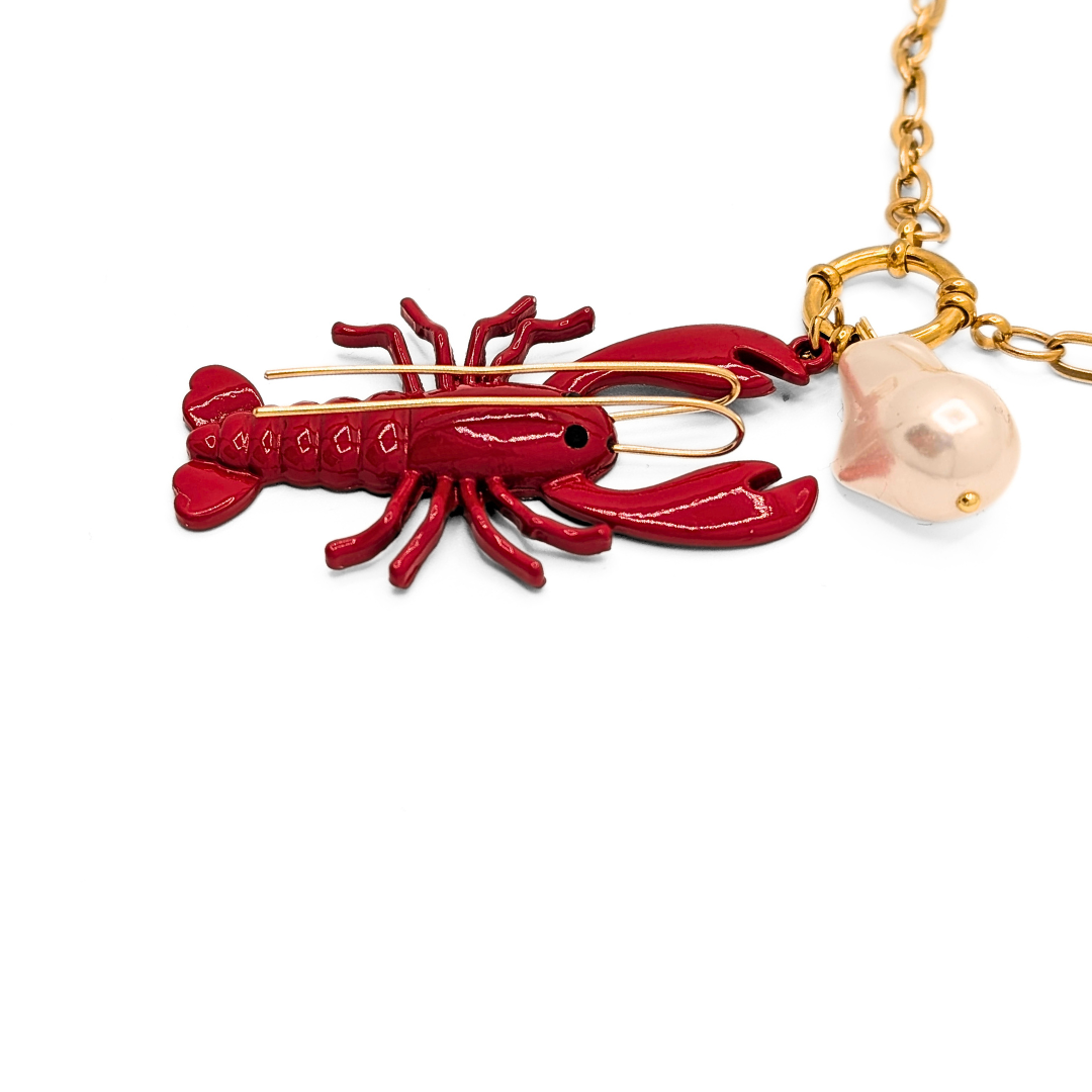 inzoom Gouden schakelketting met rode koraal bedel en witte parel hanger