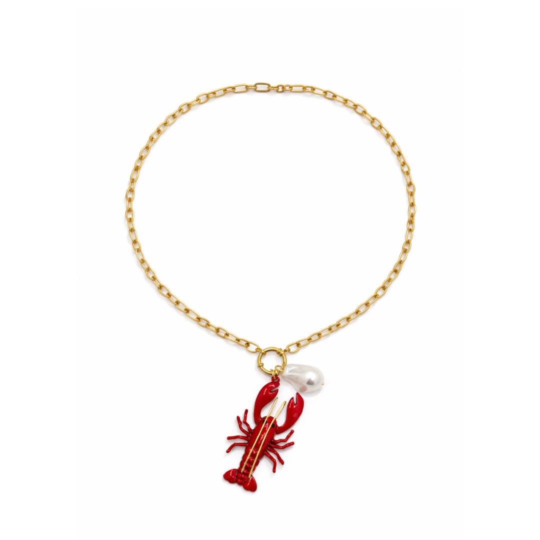 Gouden schakelketting met rode koraal bedel en witte parel hanger
