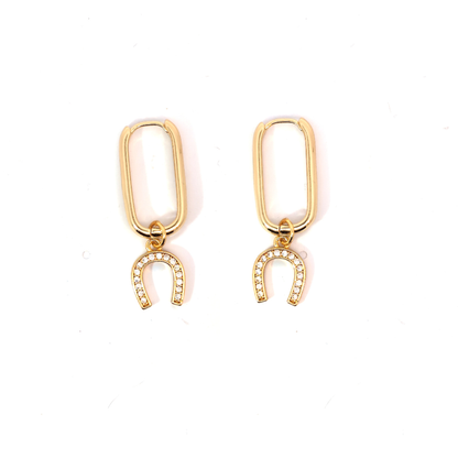 Goudkleurige oorbellen met een hoefijzer bedel bezet met kleine steentjes, stijlvolle statement oorbellen van Jadel.