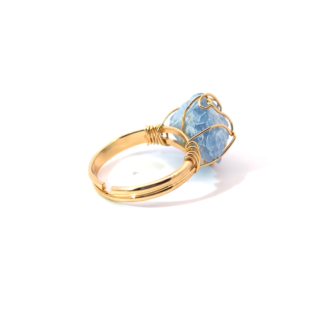 Detail van gouden ring met ruwe celestien edelsteen handgemaakt