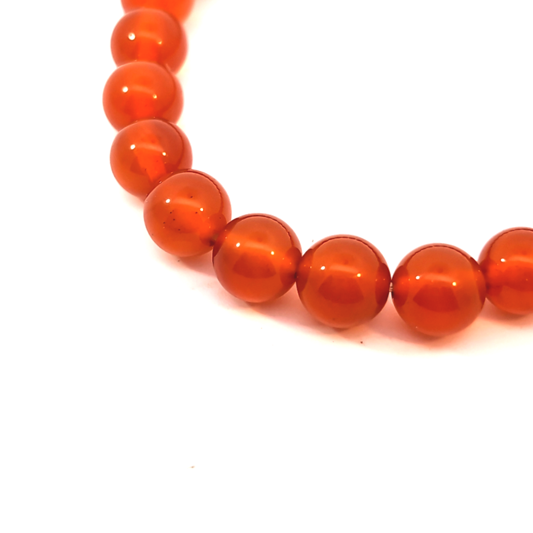 Detail van oranje citrien kralenarmband met ronde transparante edelsteen kralen