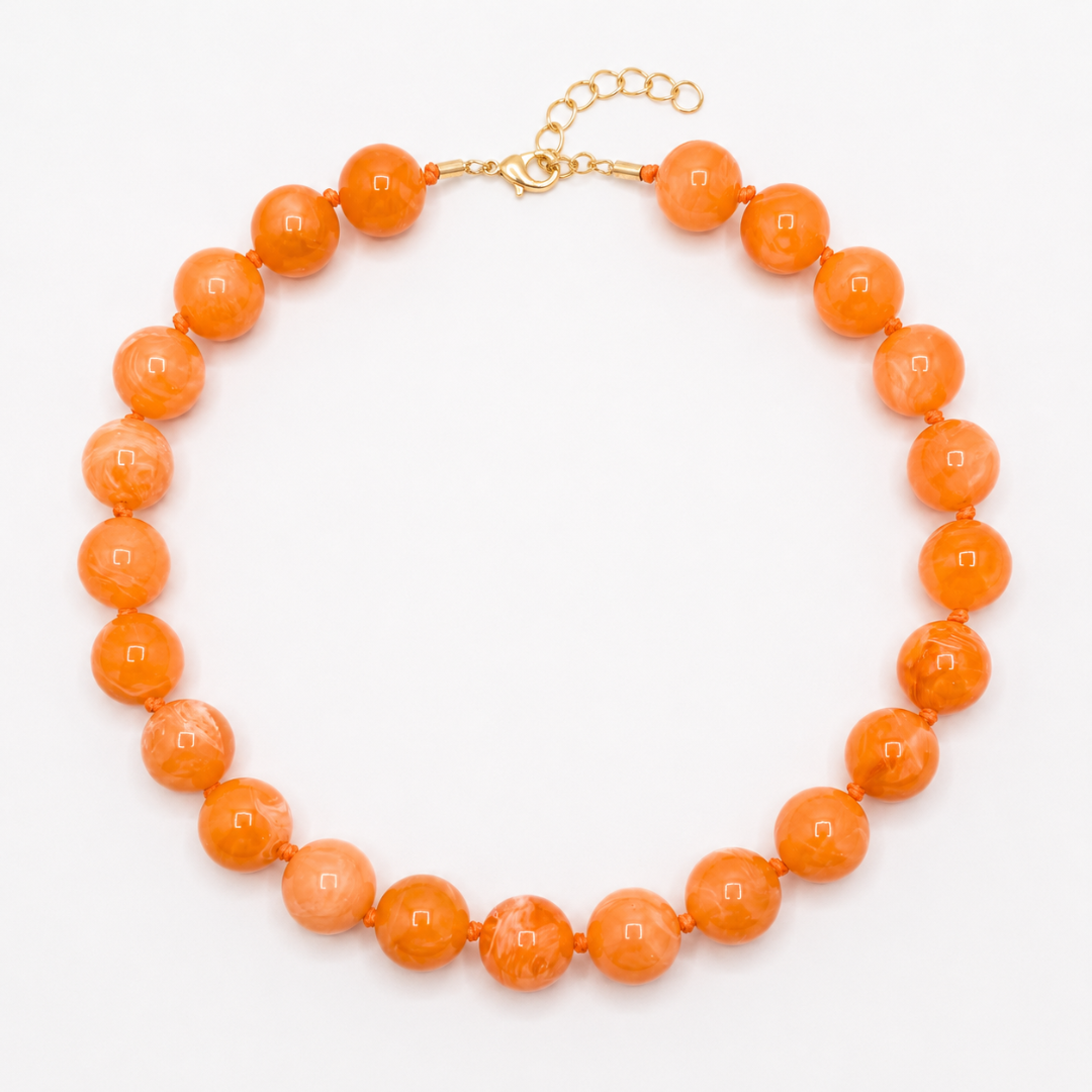 Oranje gemarmerde grote kralenketting met glossy marble kralen