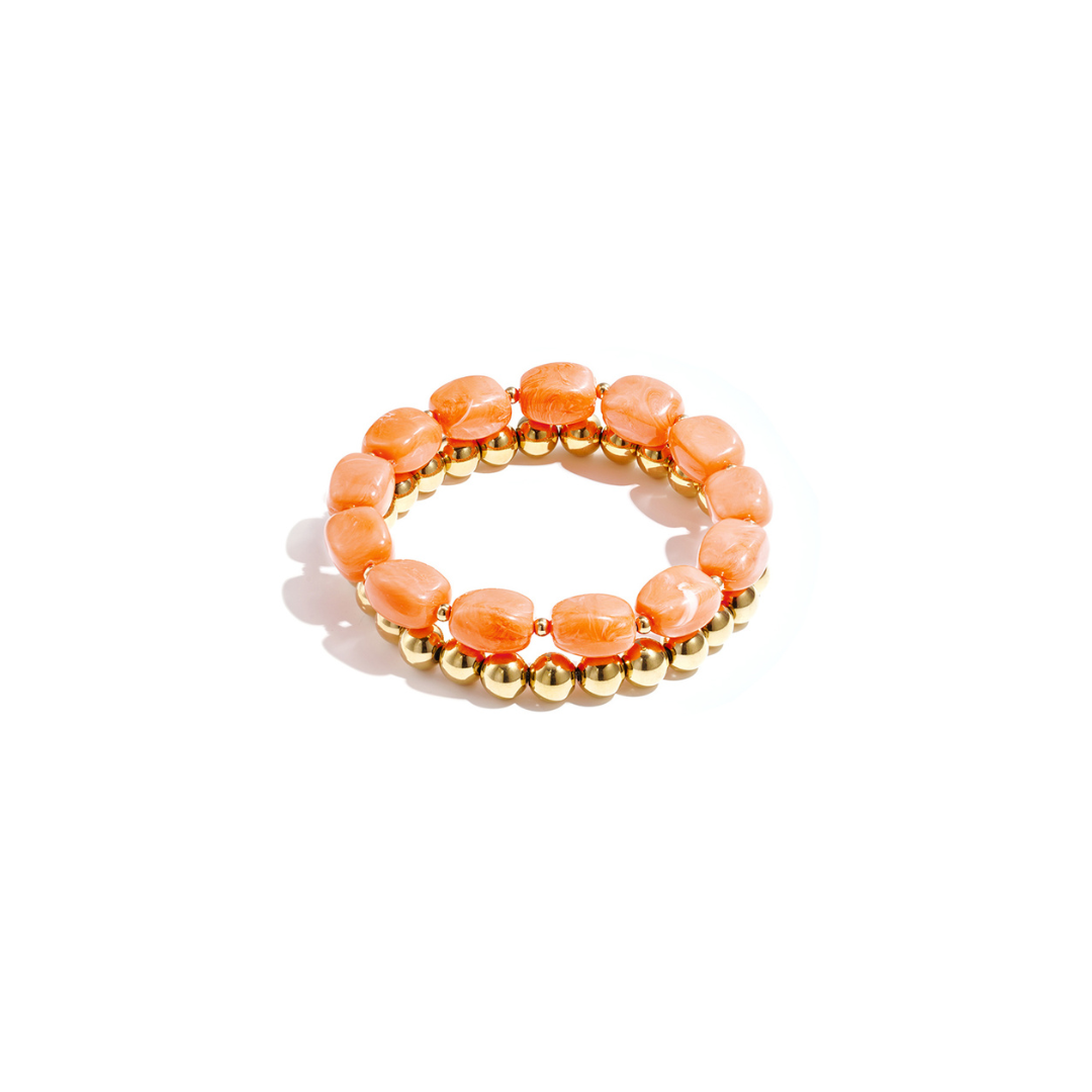 Set van oranje chunky kralenarmbanden met goudkleurige kralen voor dames.
