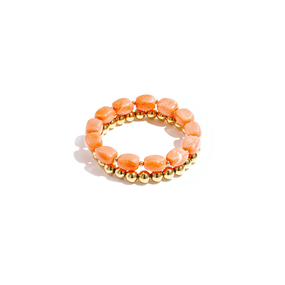 Set van oranje chunky kralenarmbanden met goudkleurige kralen voor dames.