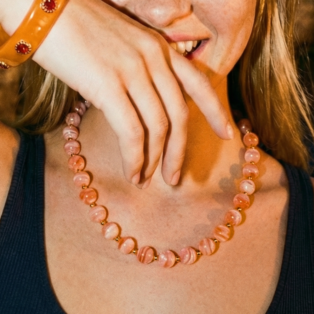 Oranje marble kralenketting Juul met grote gemarmerde kralen en goudkleurige details – elegante dames ketting van Casa Jadel.