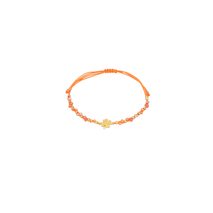 Oranje touw armbandje met gouden klavertje, glanzende kraaltjes en gouden details van Casa Jadel.