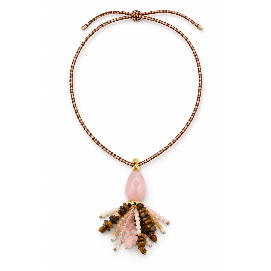 Roze-bruine lange rope ketting met schuifknoop, een roze druppelhanger en een kwastje van natuursteen kraaltjes op een witte achtergrond.