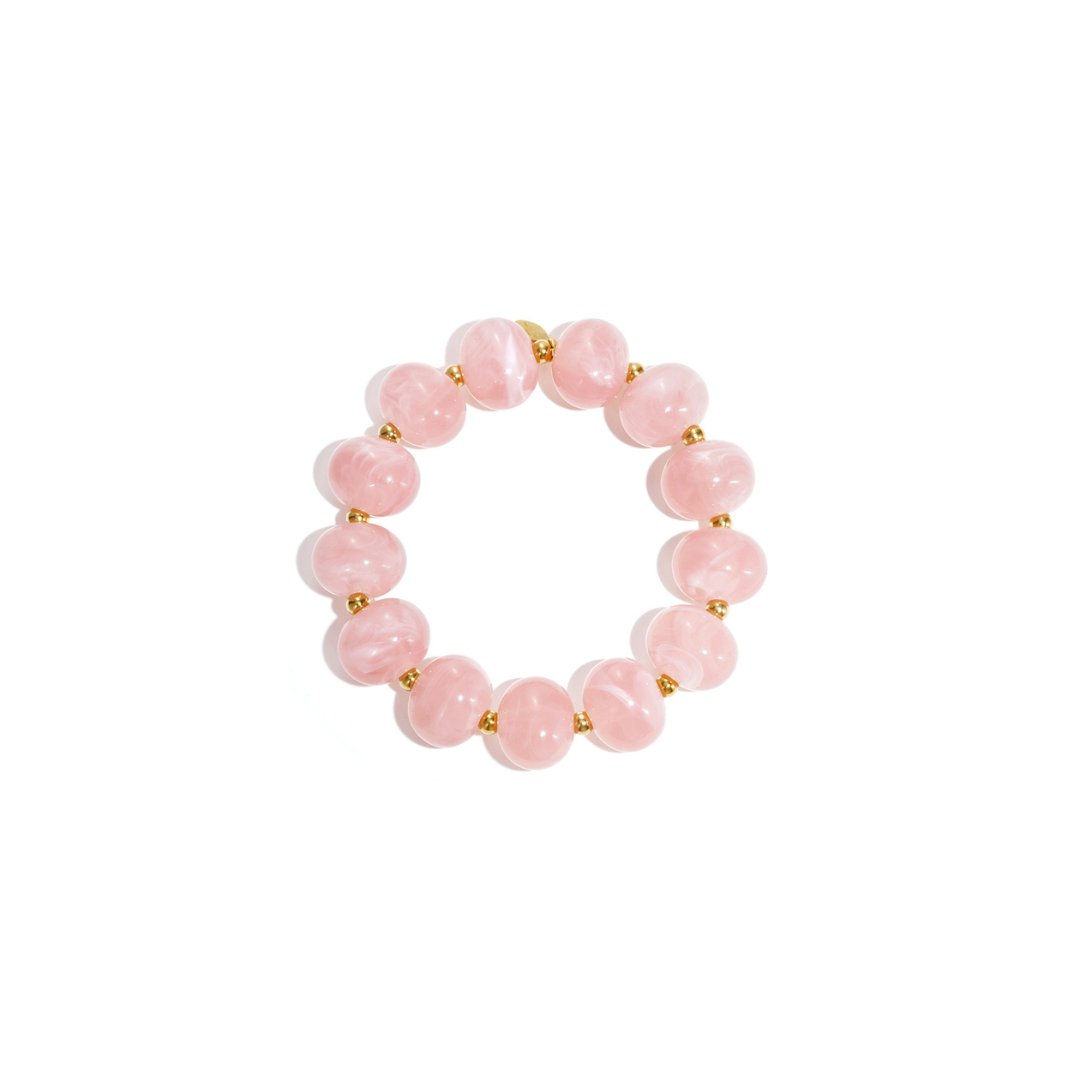 Roze kralenarmband met gemarmerde ronde kralen en goudkleurige details van Casa Jadel