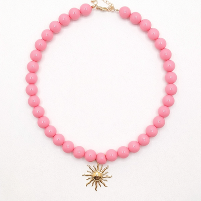 Zuurstokroze grote kralenketting gouden zon bedel