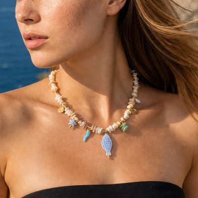 Melkwitte beige kralenketting met ocean bedels