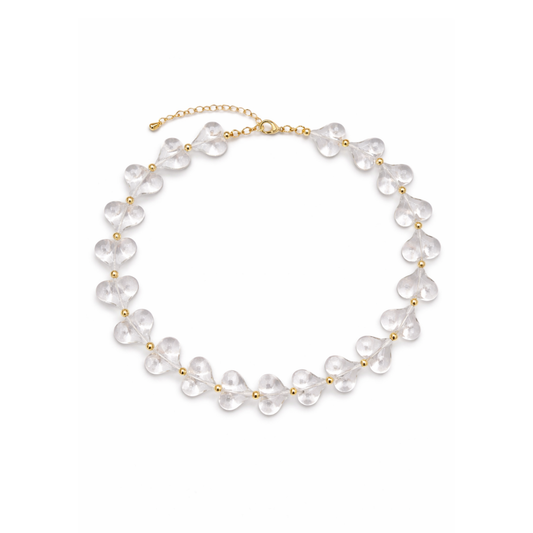 Transparante hartjes ketting met goudkleurige details en verlengketting.