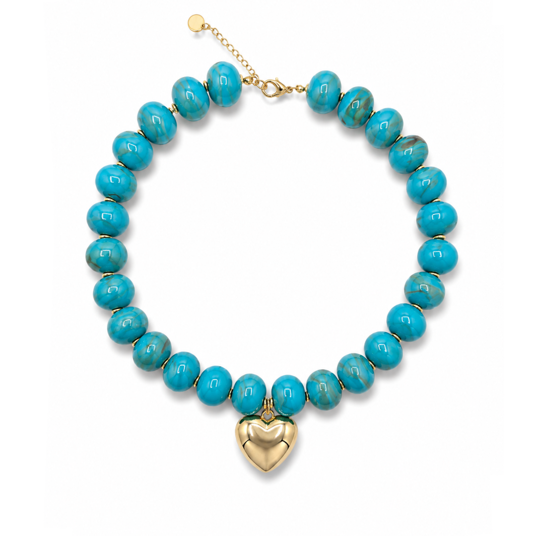 Turquoise ovale marble kralenketting Tes met goudkleurige hartbedel.