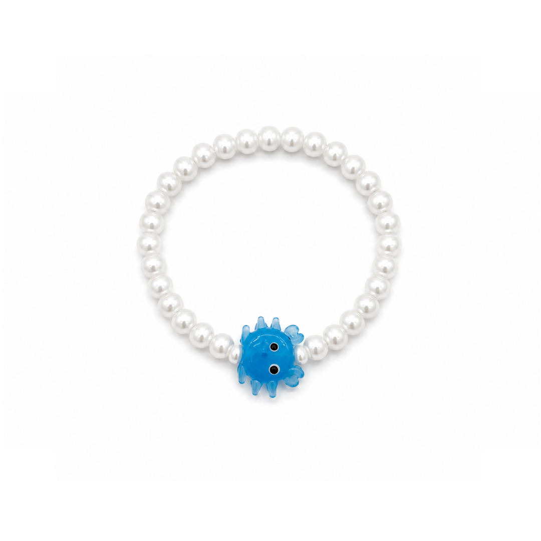 Witte parelarmband met een blauw glazen krabbetje van Casa Jadel op een witte achtergrond.